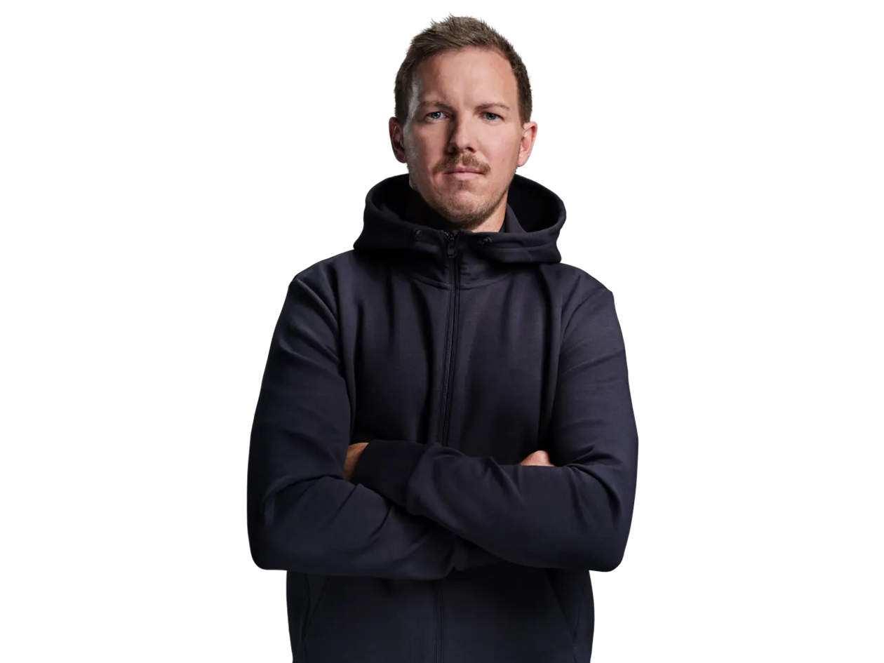 Julian Nagelsmann in a dark blue hoodie with his arms crossed.