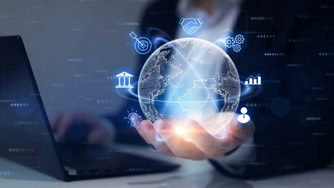 Businessman holding a glowing digital globe with orbiting industry icons, symbolizing the extended scope of directives in the global economy.