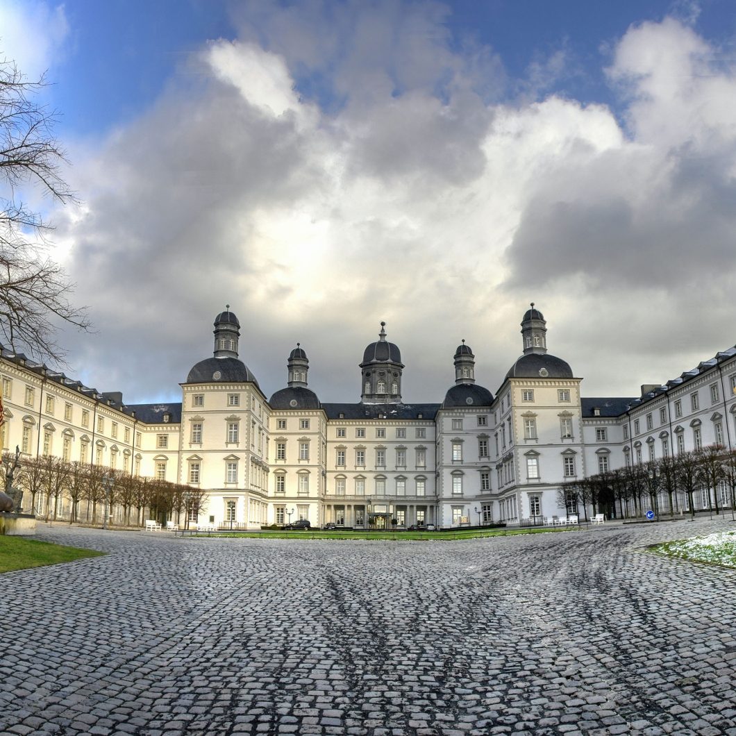 Bensberg Castle in Bergisch Gladbach with large cobblestone forecourt and baroque architecture