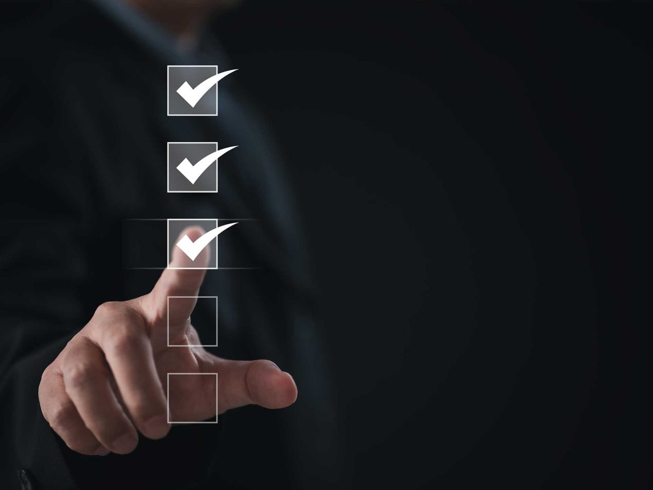 A hand selecting digital checkboxes illustrating compliance, regulatory audits, and verified security standards.