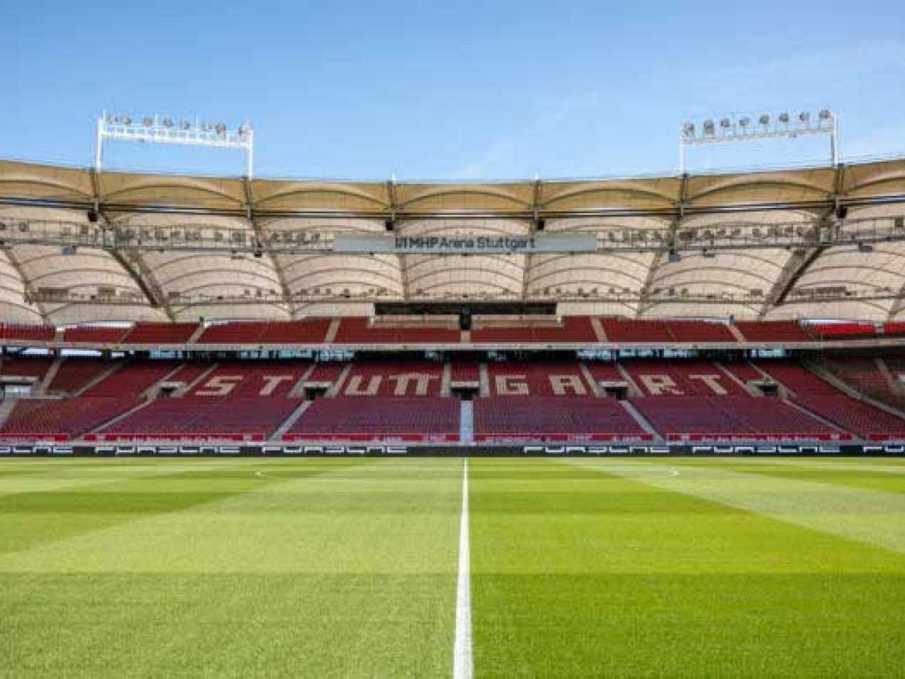 Innenansicht des MHP-Stadions Stuttgart (ehemals Mercedes-Benz Arena) mit leerer, rot bestuhlter Haupttribüne und dem frisch gemähten Fußballrasen. Spielstätte des VfB Stuttgart.