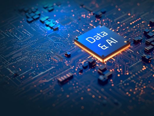 Futuristic blue glowing microprocessor on a circuit board featuring the text "Data & AI" with orange light trails and digital data connections.