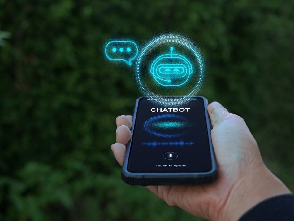Person holding a smartphone with a chatbot interface and voice assistant display outdoors. A futuristic AI bot icon and voice wave float above the screen.